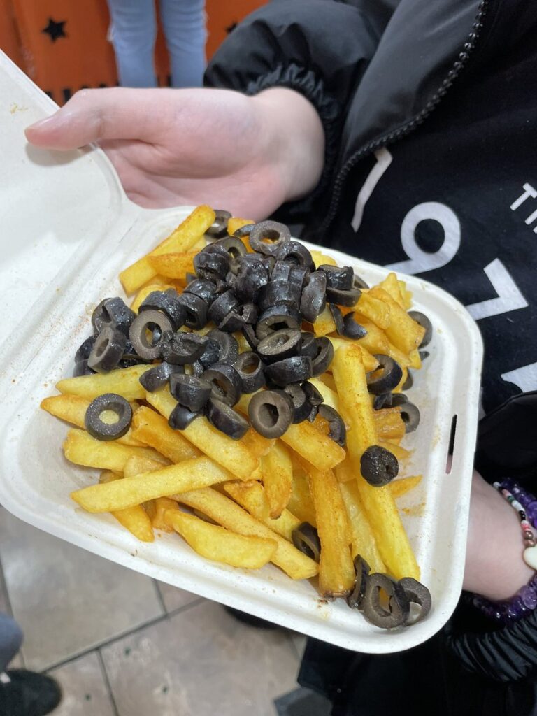 Vegan's bizarre takeaway combo of chips topped with olives shocks social media. Is it genius or gross? See the viral reaction to this unusual Manchester dish!