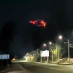 Stunned woman captures mysterious red 'UFO' hovering in Chile's night sky, sparking a viral sensation and social media buzz with theories and reactions.