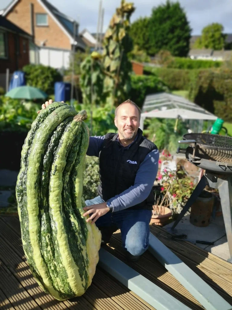 Britain's giant veg king, Kevin Fortey, holds 11 world records, including the tallest cucumber and longest aubergine. His giant veggie-growing skills inspire gardeners worldwide.