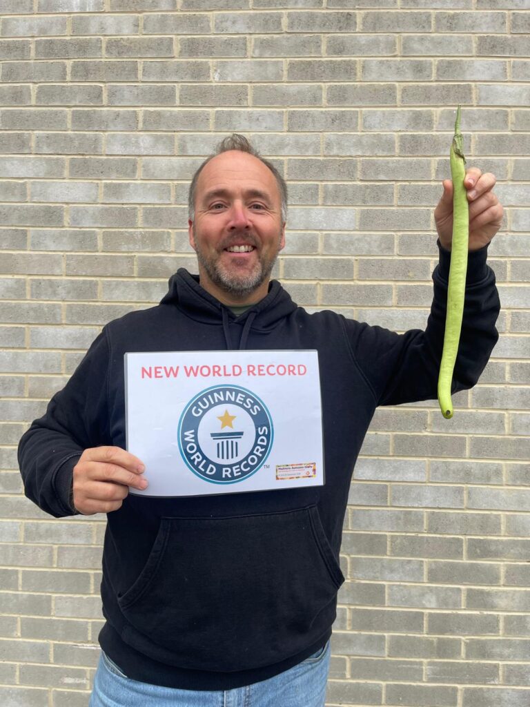 Britain's giant veg king, Kevin Fortey, holds 11 world records, including the tallest cucumber and longest aubergine. His giant veggie-growing skills inspire gardeners worldwide.