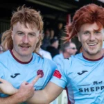 Taunton Town FC fans sport ginger mullet wigs in support of captain Tom Smith, sparking a booming trend at matches. The quirky craze has taken the club's home games by storm!