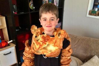 Dad spends four hours baking 340 Yorkshire puddings to create a viral Halloween costume for his kids, Yorkshire Pudding Boy, amassing over 2.9 million views online.