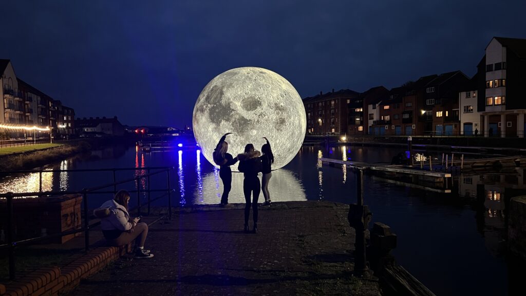 Luke Jerram's 30ft inflatable moon deflates twice due to storm damage in Somerset, cutting short the popular outdoor installation that had attracted over 10,000 visitors.