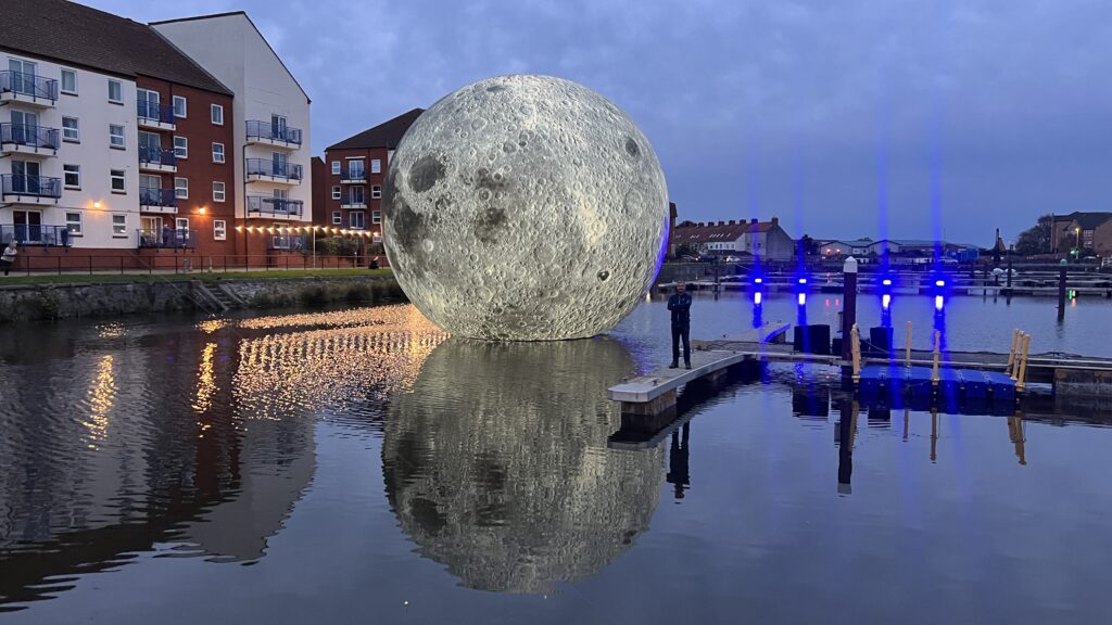 Luke Jerram's 30ft inflatable moon deflates twice due to storm damage in Somerset, cutting short the popular outdoor installation that had attracted over 10,000 visitors.