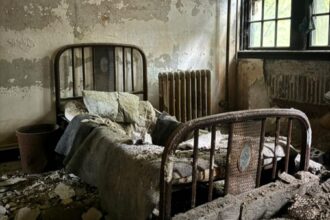 Explore eerie photos of Medfield State Hospital, the abandoned asylum turned film set for movies like Shutter Island, now open to public for a chilling look inside.