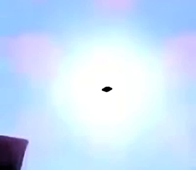 UFO spotted hovering above petrol station in Cuernavaca, Mexico, sparking debate as locals film mysterious craft silhouetted by the sun.