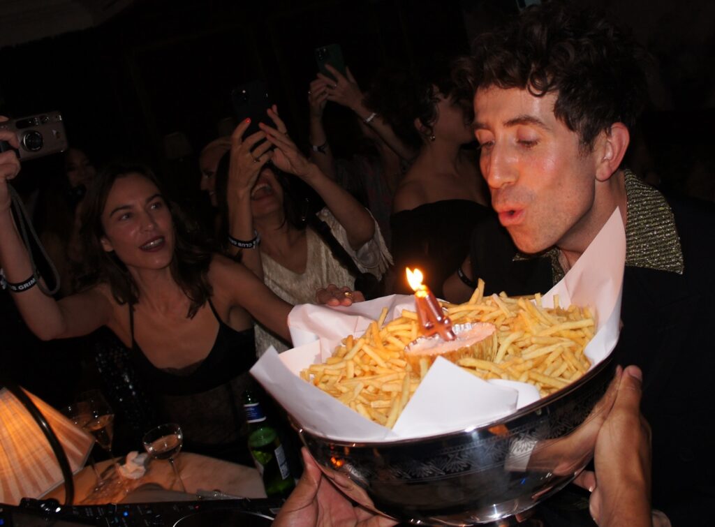 Nick Grimshaw surprises fiancé Mesh Henry with a quirky birthday "cake" made of Scampi Fries, delighting fans with the creative twist. The playful moment goes viral on Instagram.