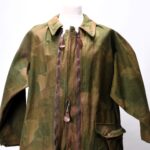 Rare WWII British SOE camouflage suit, designed for secret agents behind enemy lines, up for auction. Unique artifact includes quick-disposal features and hidden pockets.