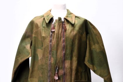 Rare WWII British SOE camouflage suit, designed for secret agents behind enemy lines, up for auction. Unique artifact includes quick-disposal features and hidden pockets.