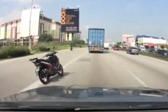 A 'ghost' motorbike stunned drivers on Malaysia's Federal Highway after merging riderless onto the road. The eerie scene was later explained as a collision causing the rider to fall.