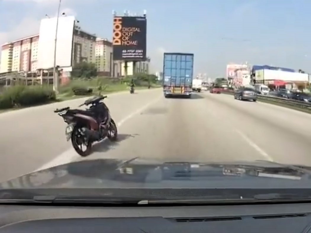 A 'ghost' motorbike stunned drivers on Malaysia's Federal Highway after merging riderless onto the road. The eerie scene was later explained as a collision causing the rider to fall.