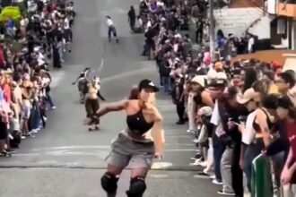 A roller skater loses control at Medellín's Loma Hill Bomb, crashing into spectators and causing laughter-filled chaos in the thrilling biannual skating event.