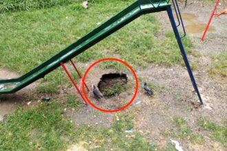 A sinkhole opens under a playground slide in Medellín, Colombia, prompting parents to evacuate children and demand urgent action from authorities to prevent potential accidents.