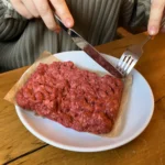 Fine art student Tatum Parden went viral after eating what appeared to be raw mince, but it was actually a hyperrealistic cake. Her TikTok stunt left viewers stunned and amused.