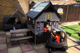 DIY dad builds McDonald's drive-thru and pub playhouses for his kids using recycled materials. Unique creations cost under £30, sold for £250, and inspired many parents.