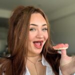 Woman opens up about intimacy challenges with dentures, overcoming self-confidence struggles after losing her teeth at 19, and embracing a newfound smile with support from her partner.