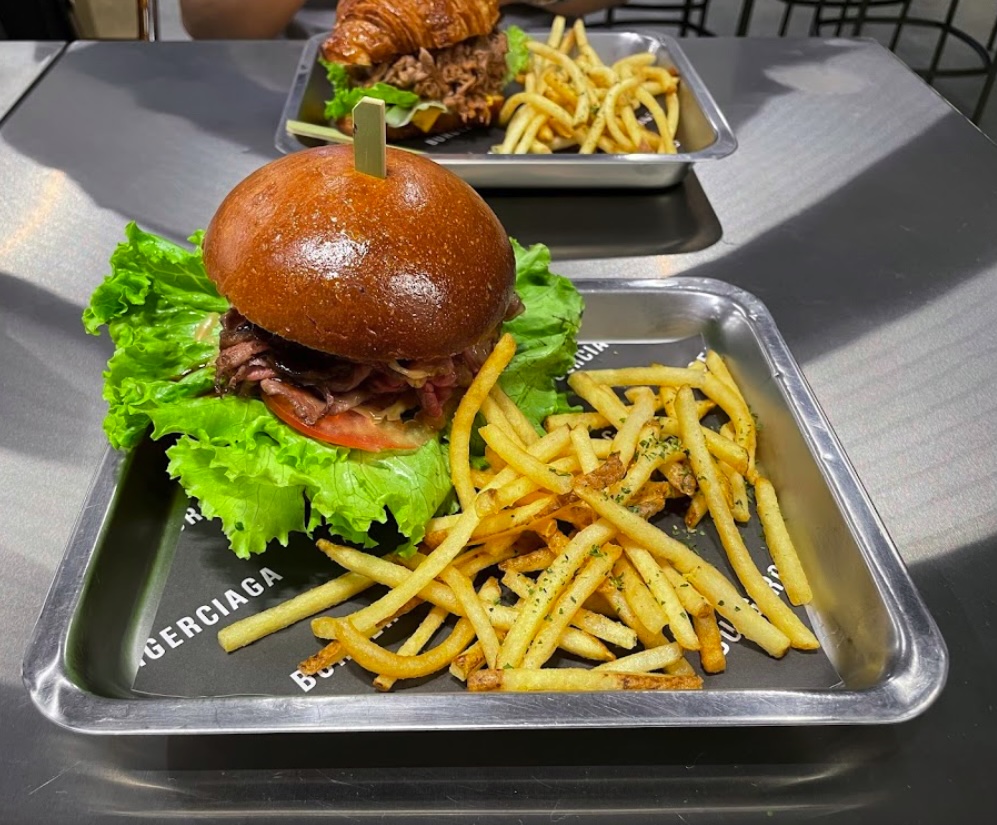 Burgerciaga, a Balenciaga-inspired burger joint in Taipei, wows diners with chic design and affordable prices, offering gourmet burgers under £15 in a luxury setting.