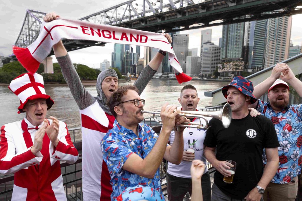 Barmy Army trumpeter Simon Finch sparks Ashes excitement atop Sydney Harbour Bridge, marking one year until England vs Australia 2025 series. Plan your trip now!