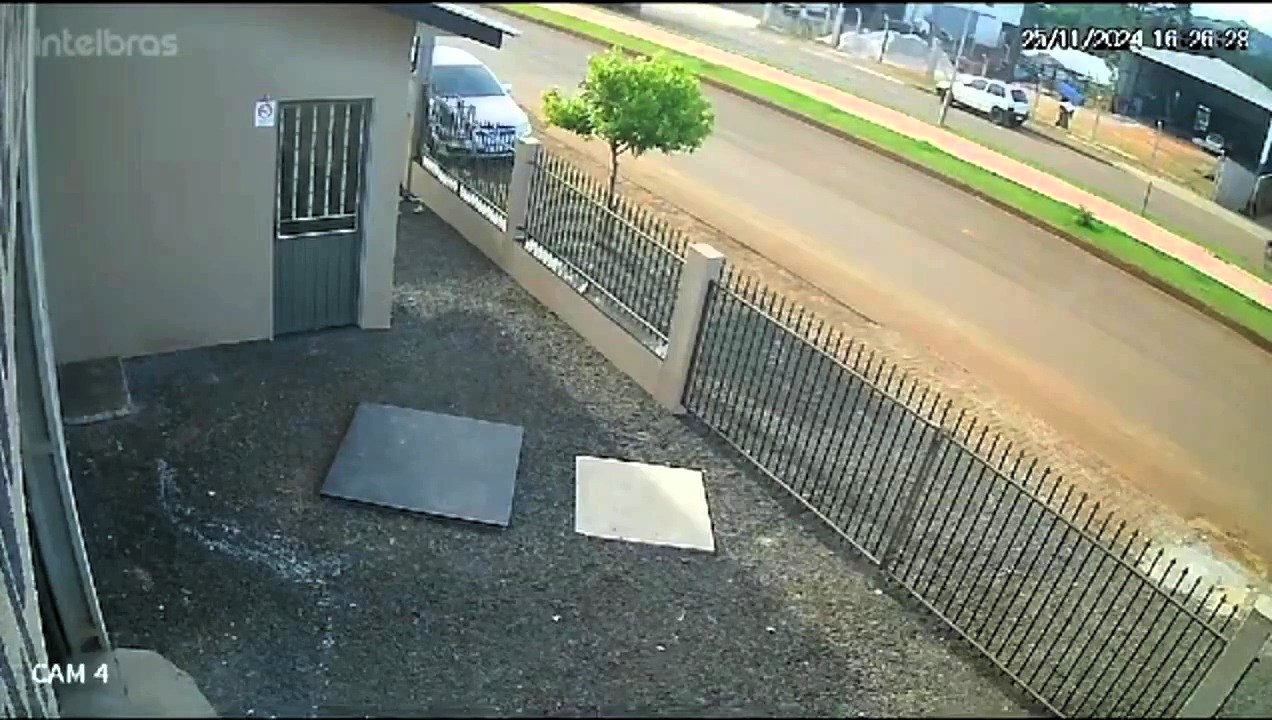 A stationary car mysteriously flips over its bonnet in Brazil, caught on CCTV. A snapped cable tangled by a passing lorry may have caused the bizarre accident.