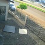 A stationary car mysteriously flips over its bonnet in Brazil, caught on CCTV. A snapped cable tangled by a passing lorry may have caused the bizarre accident.