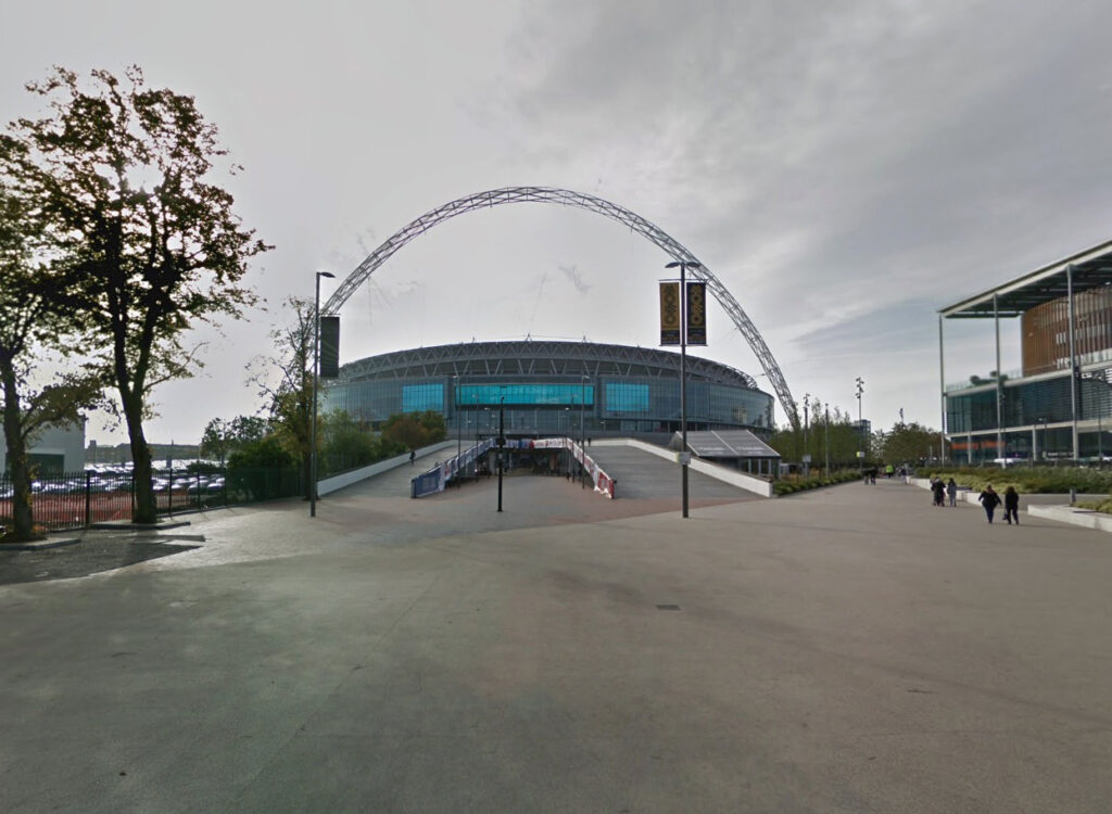 England fan slams Wembley Stadium snack after receiving bland chips with an unmelted cheese slice, sparking outrage over the disappointing pre-match food.