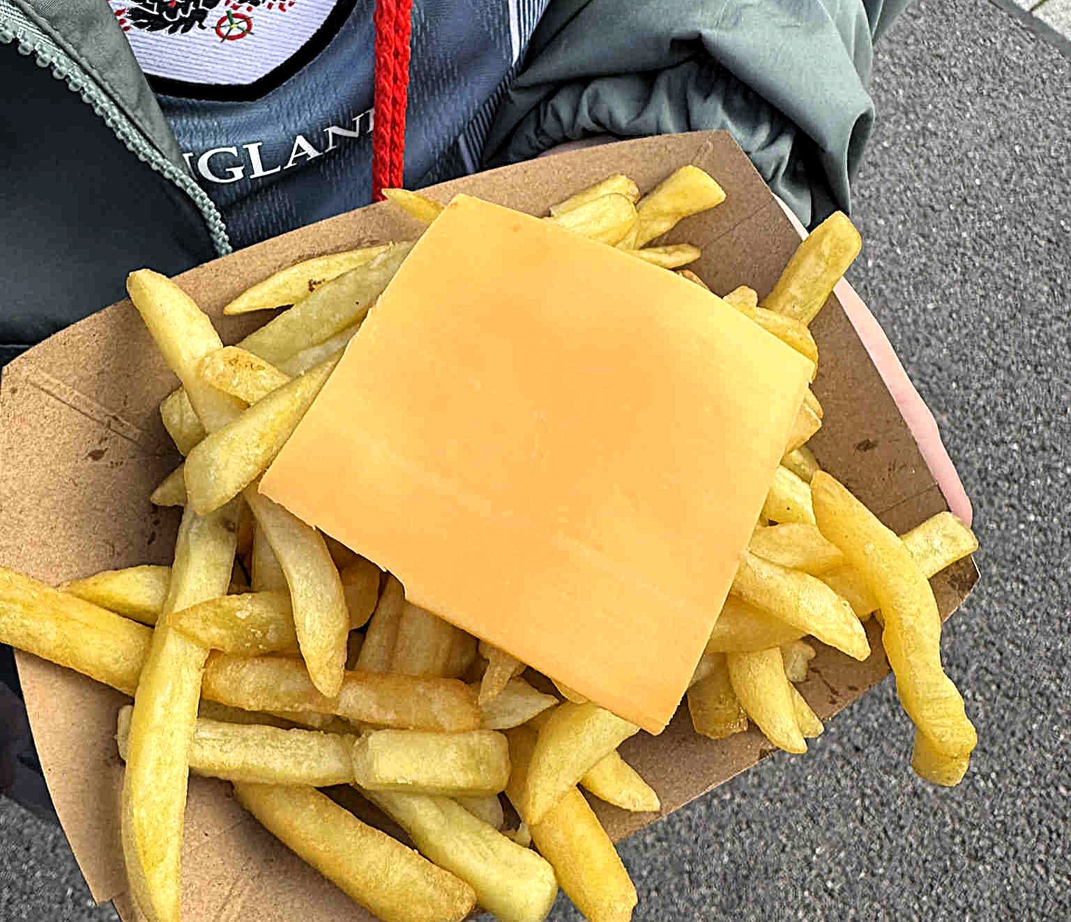 England fan slams Wembley Stadium snack after receiving bland chips with an unmelted cheese slice, sparking outrage over the disappointing pre-match food.