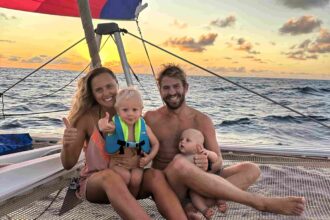 A family living on a sailboat shares how their minimalist Christmas focuses on traditions, memories, and unique adventures, from toy cars to festive meals at sea.