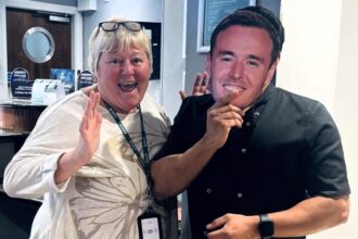 Holiday Inn staff in Bolton don Alan Halsall masks to cheer on the I'm A Celeb star, best known as Tyrone Dobbs in Corrie. Fans and locals rally behind him!