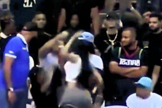 Influencer Yailin’s courtside brawl at Dominican basketball game goes viral; heated exchange halts game as bystanders intervene, leaving fans speculating on the cause.