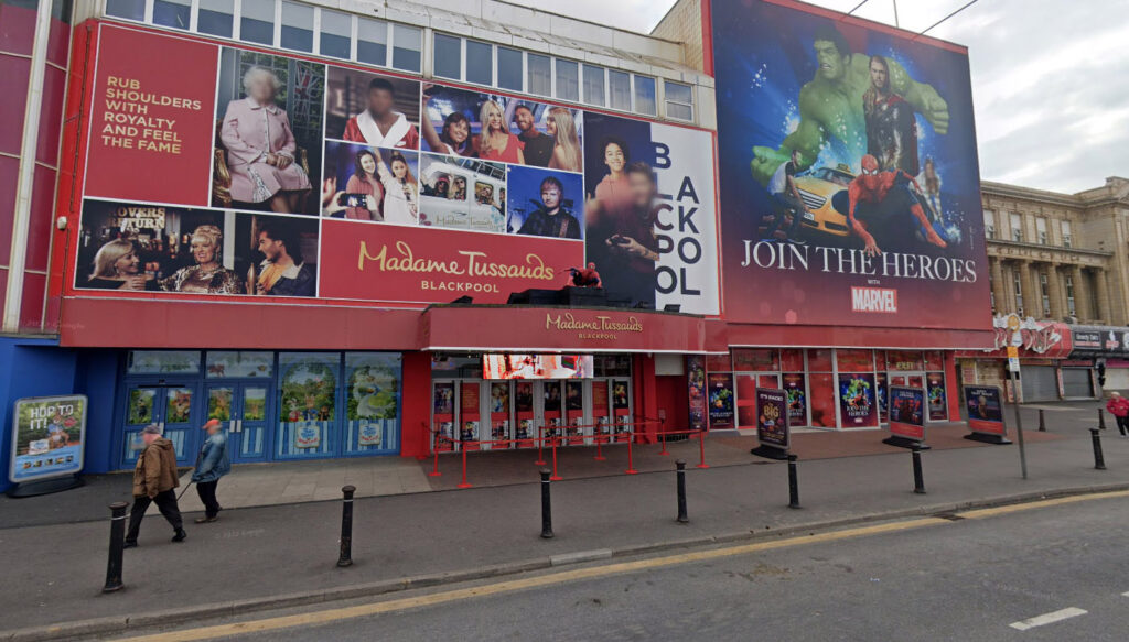 John Bishop’s Madame Tussauds waxwork returns after his hilarious reaction to its absence; the comic jokes about giving it a youthful revamp and fresh teeth!