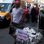 Entrepreneur sells Trump-branded toilet paper on London’s Regent Street following his re-election, sparking reactions from confused and amused passers-by.