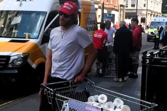 Entrepreneur sells Trump-branded toilet paper on London’s Regent Street following his re-election, sparking reactions from confused and amused passers-by.