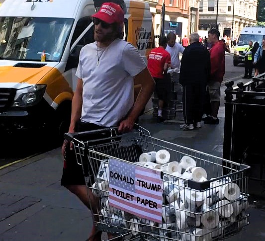 Entrepreneur sells Trump-branded toilet paper on London’s Regent Street following his re-election, sparking reactions from confused and amused passers-by.