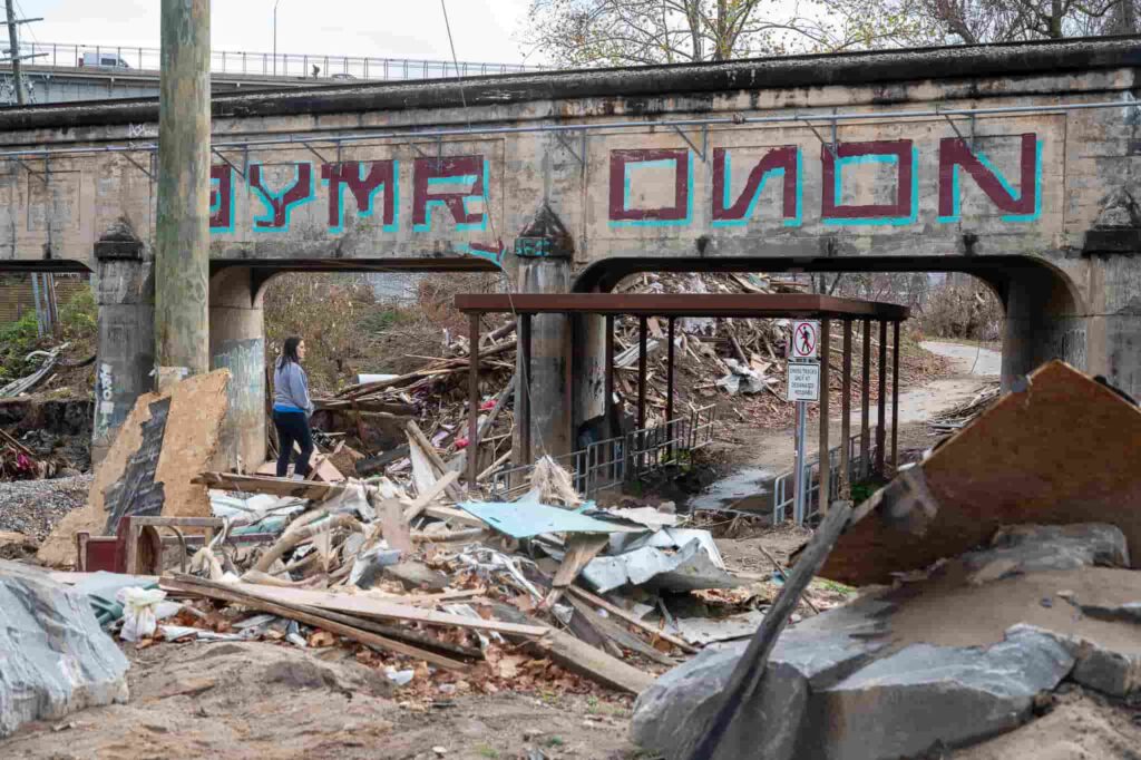 A videographer captures the devastating aftermath of Hurricane Helene in Florida, two months on. Homes destroyed, debris piled high, and messages of resilience remain.