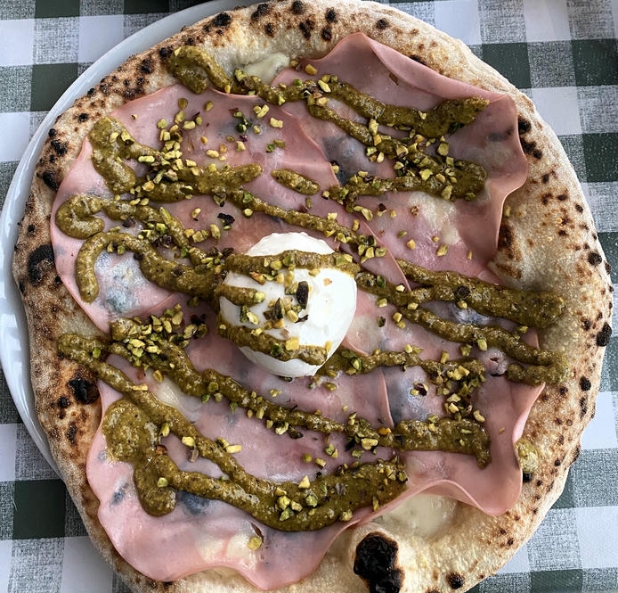 Pizza Pilgrims launches festive pizza 'It’s a Wonderful Slice' with unique pistachio and burrata toppings. We taste-tested the Christmas special – here’s the verdict.