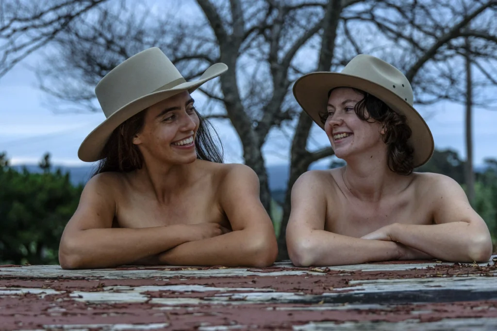 University students bare all for the 2025 "Flash for Farmers" calendar, raising funds for Rural Aid with creative nude shots featuring tractors, animals, and farm scenes.