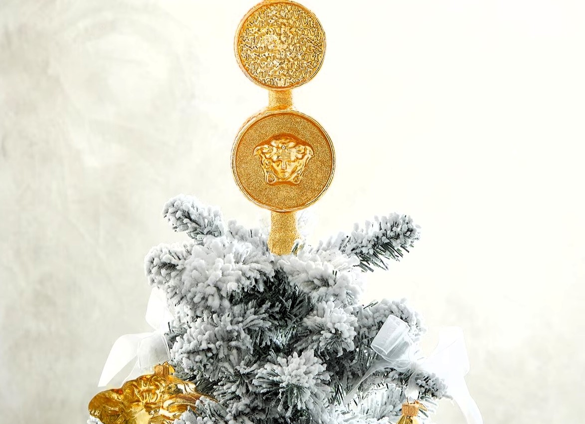 Versace is selling luxury Christmas tree toppers for up to £495, featuring Medusa and coin designs in glittery gold glass, sparking buzz over the festive splurge trend.