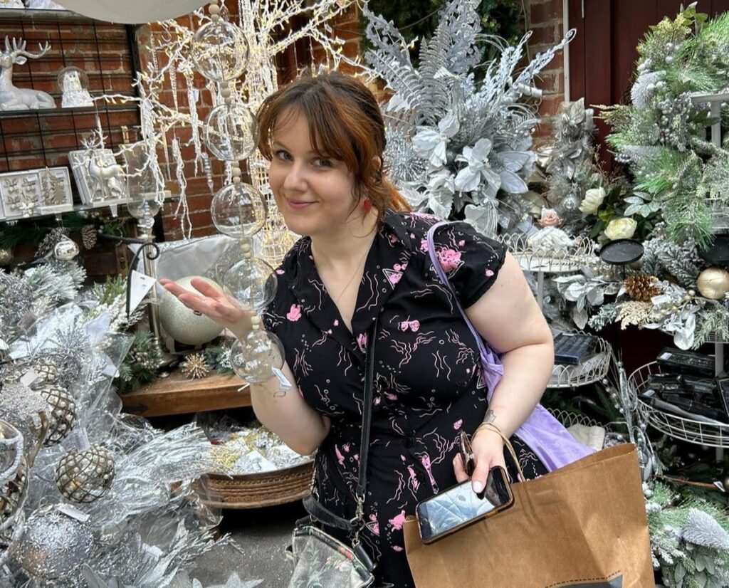 Grieving her mum's loss, a woman dubbed the "real-life Grinch" spends Christmas solo, embracing movies and takeout while sharing her story to normalize festive grief.