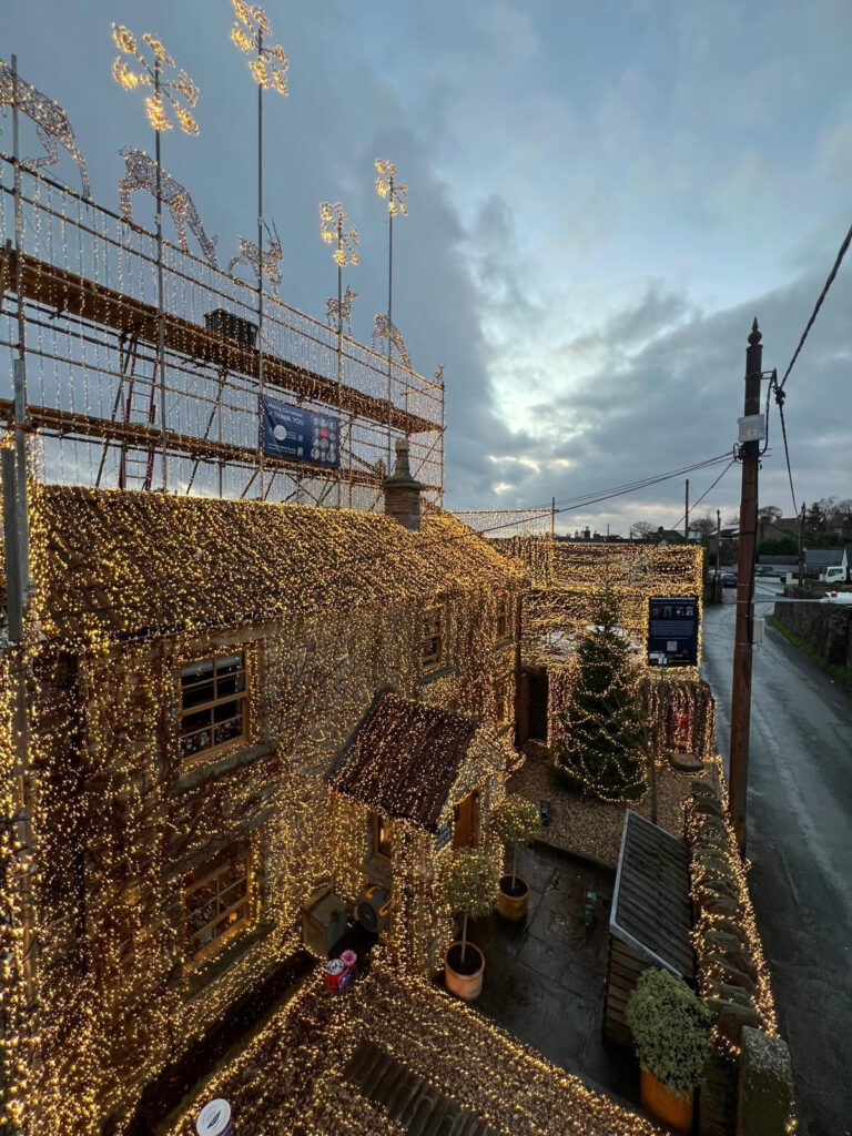 Britain's most festive home dazzles with over 200,000 Christmas lights, raising funds for veterans. Owner Richard Iles' stunning display draws praise and supports a vital cause.