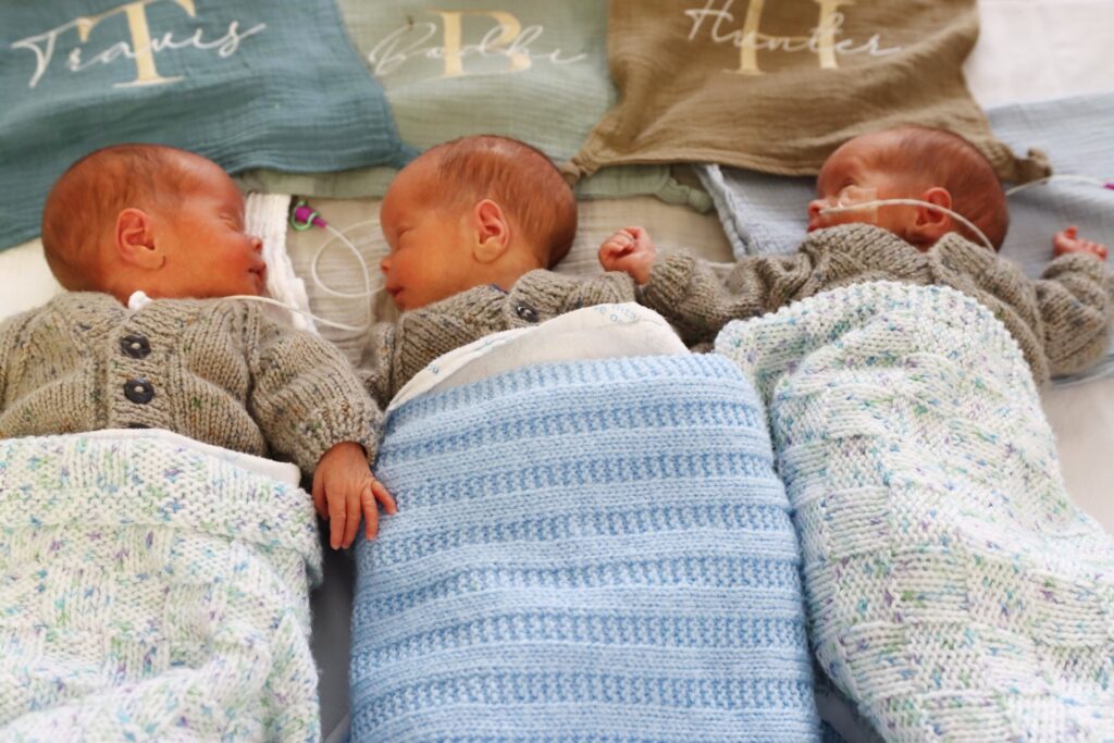 A couple defied odds of up to 200 million-to-one by having natural identical triplets. Now home after weeks in NICU, the boys join their siblings for a magical Christmas.