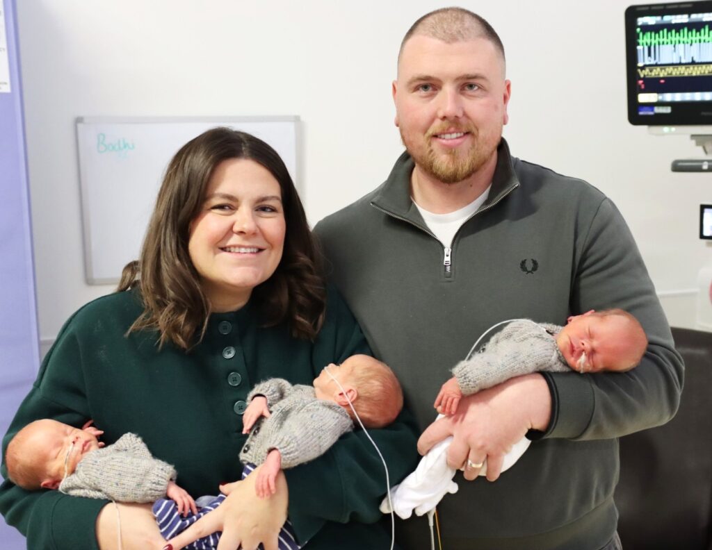 A couple defied odds of up to 200 million-to-one by having natural identical triplets. Now home after weeks in NICU, the boys join their siblings for a magical Christmas.