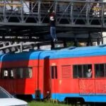 Daredevils in Santa hats filmed running along a moving train in Bogotá, drawing awe and criticism. The risky stunt on a tourist train sparks calls for safety awareness.