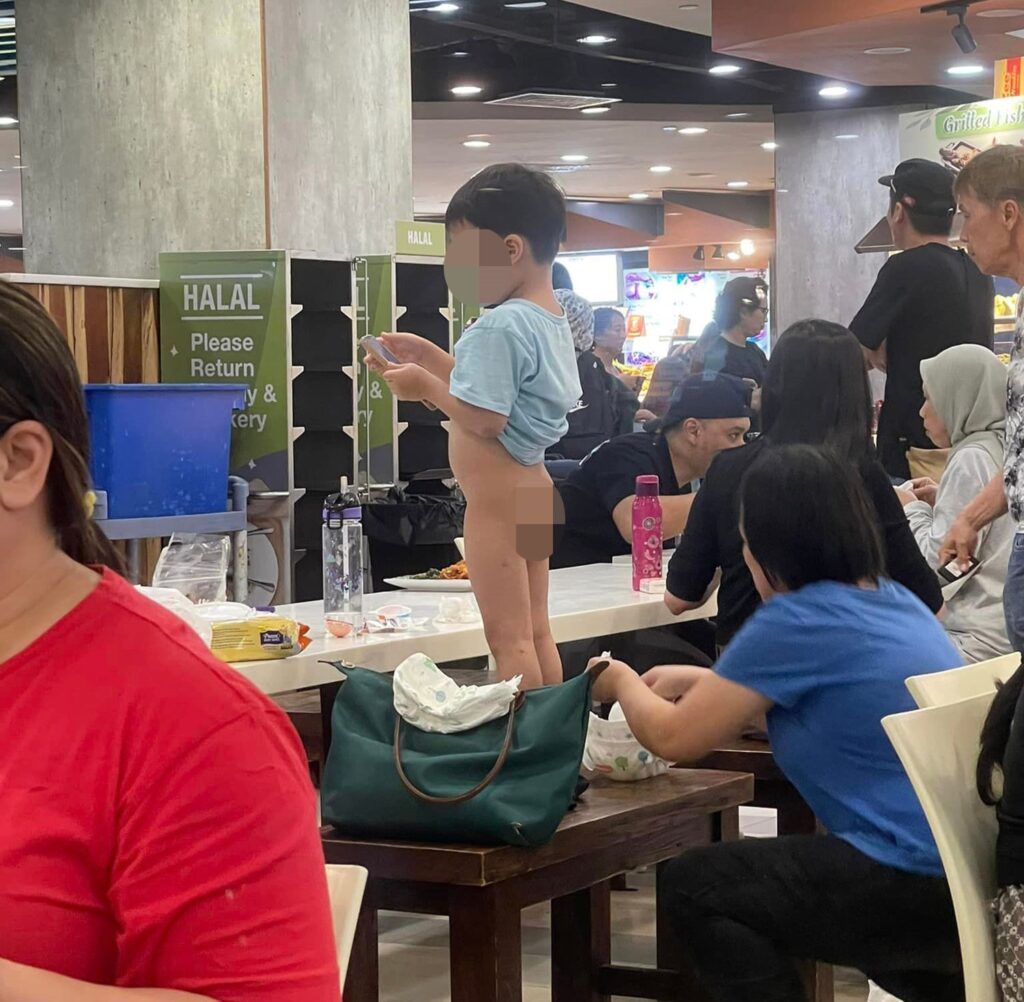 Diners were shocked as a mum changed her toddler's dirty nappy on a dining bench at a busy Singapore restaurant, sparking complaints about hygiene and public etiquette.