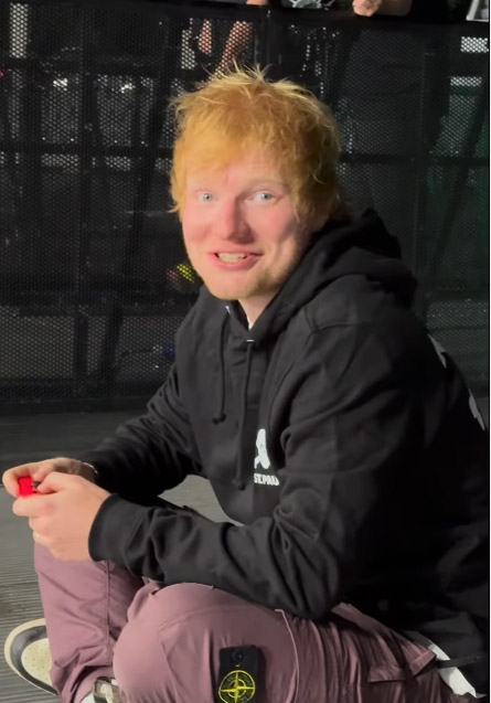 Woman spots Ed Sheeran's face in her milkshake maker, leaving friends in stitches. The uncanny resemblance to his album cover has fans crying, "Let Ed out!"