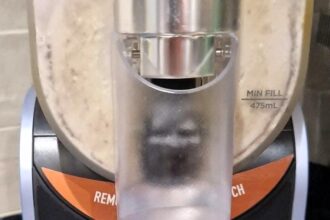 Woman spots Ed Sheeran's face in her milkshake maker, leaving friends in stitches. The uncanny resemblance to his album cover has fans crying, "Let Ed out!"