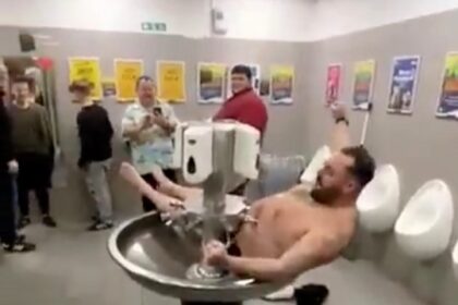 Exeter City fan takes a post-match dip in a motorway service station sink after a 2-0 loss to Stockport County, splitting opinions with his bizarre antics.