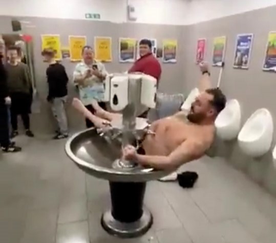 Exeter City fan takes a post-match dip in a motorway service station sink after a 2-0 loss to Stockport County, splitting opinions with his bizarre antics.