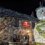 Britain’s most festive pub, The Queen Victoria Inn, stuns with 55,000 lights and a 26ft snowman made of 2,500 wine bottles, raising funds for Children's Hospice South West.