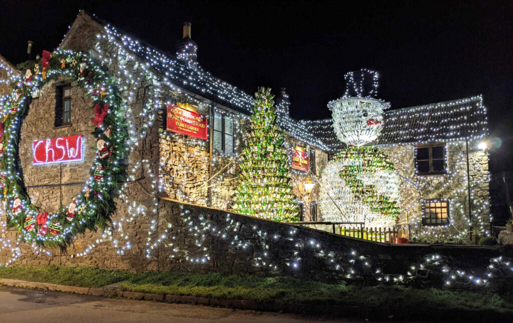 Britain’s most festive pub, The Queen Victoria Inn, stuns with 55,000 lights and a 26ft snowman made of 2,500 wine bottles, raising funds for Children's Hospice South West.