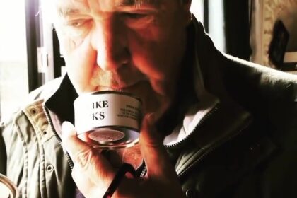 Jeremy Clarkson doubles the price of his cheeky "This Smells Like My Bollocks" candle to £22.50, sparking debate over inflation and festive splurges at Diddly Squat Farm Shop.